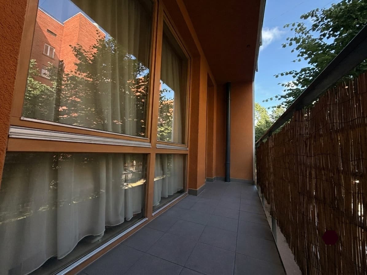 Balcony view with trees and soft natural light